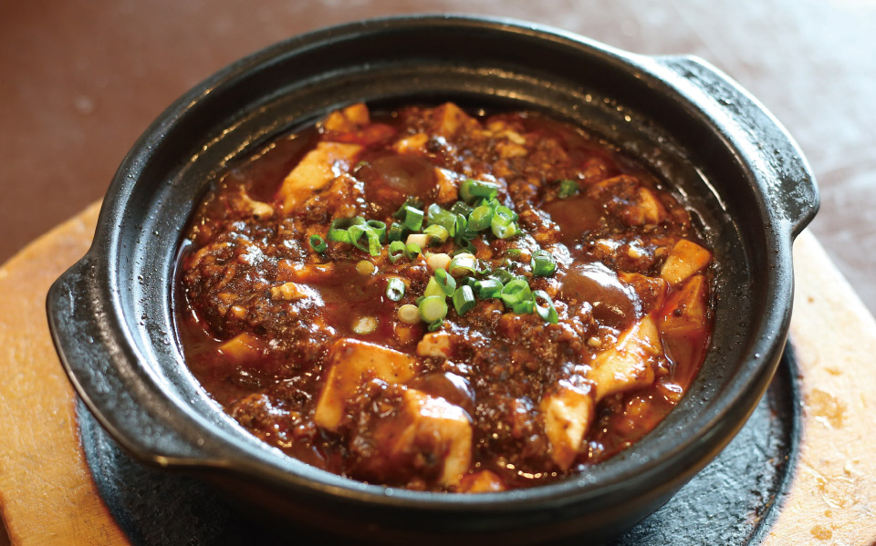 土鍋麻婆豆腐680円は、黒豆の味噌とスパイスを使った本場の味つけ